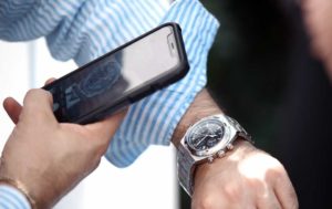 man taking picture of his watch