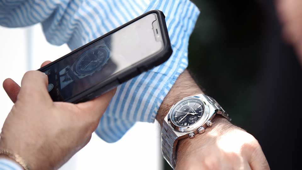 man taking picture of his watch