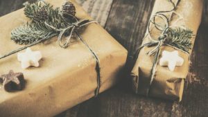 Holiday gifts wrapped in brown paper with holiday decorations