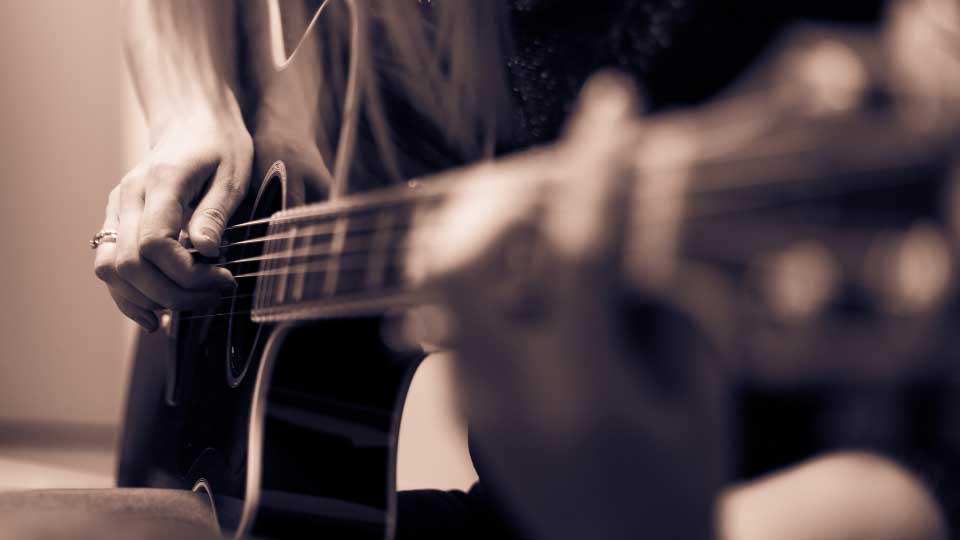 musician playing a guitar