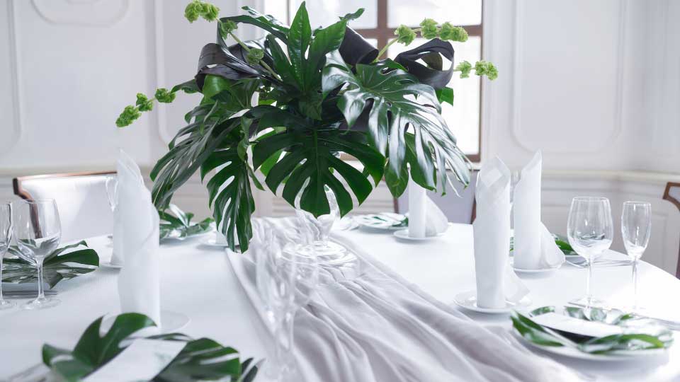 Wedding served table setting of palm tree leaves