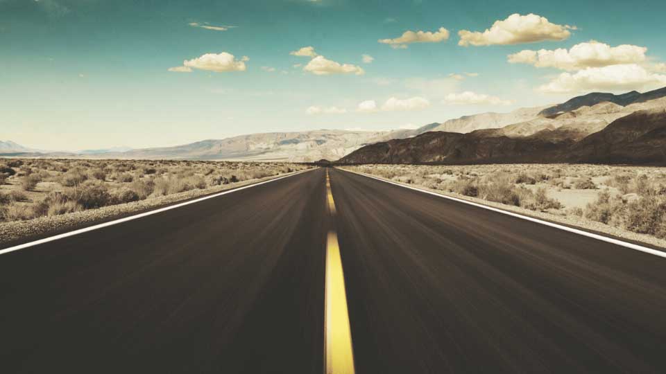 A view of a road going thru the desert