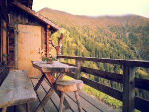 2. brown wooden table and bench overlooking mountains