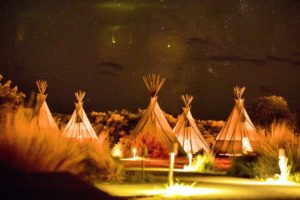 4. tipi tents with campfire in the background
