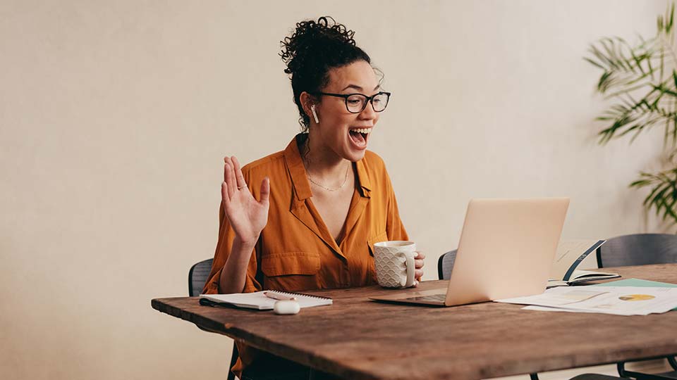 Happy woman in front of computer