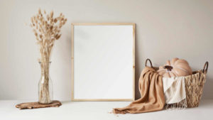 Organic scenery with vase dry flowers, basket, decorative pumpkin andcashmere scarves