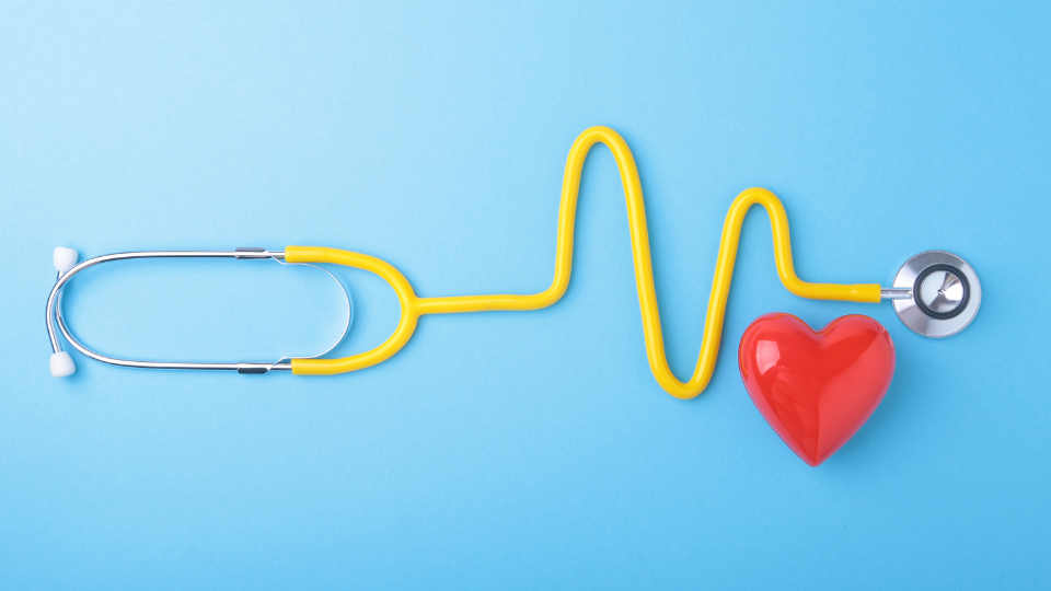 Health check Red heart and a stethoscope on blue background