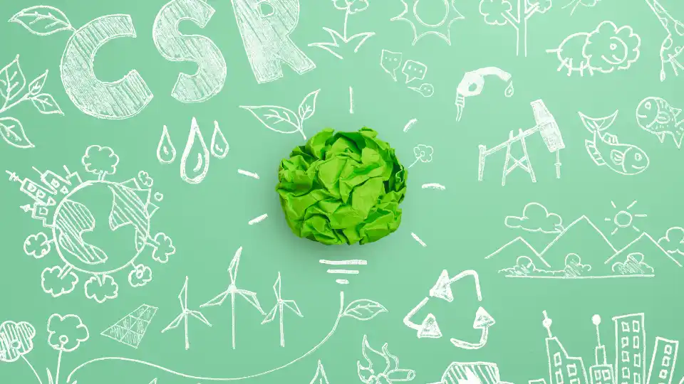 Corporate Social Responsibility (CSR), eco-friendly business concept with crumpled green paper light bulb and environmental sketch on green background